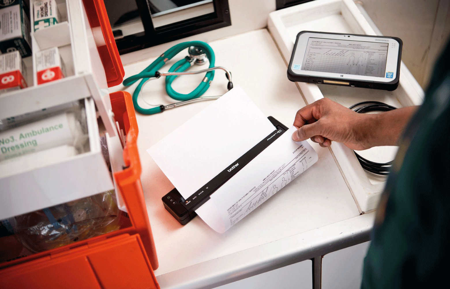 Ambulance desk with medical equipment and pj printer printing patient notes