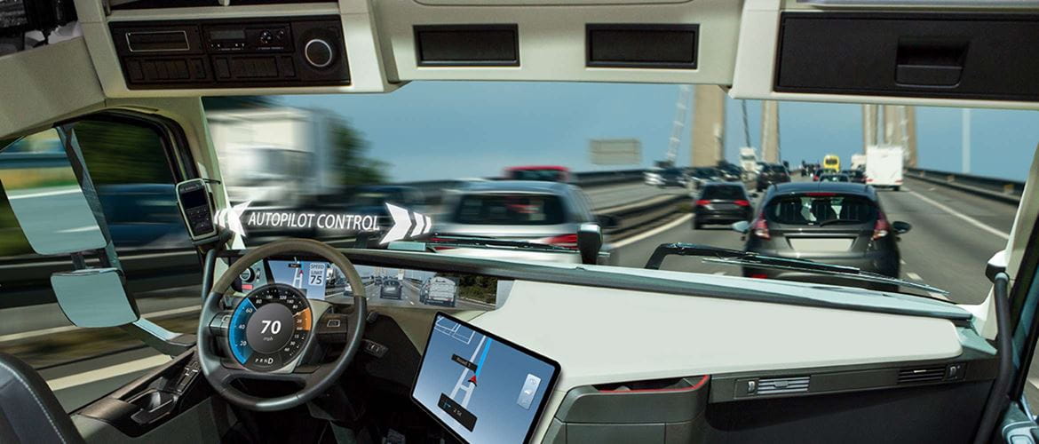 Un camion sans conducteur est conduit par pilotage automatique sur une autoroute à la circulation intense. Une tablette affiche les informations de navigation par satellite sur le tableau de bord de cette scène, illustrant l'innovation dans le secteur du transport et de la logistique.