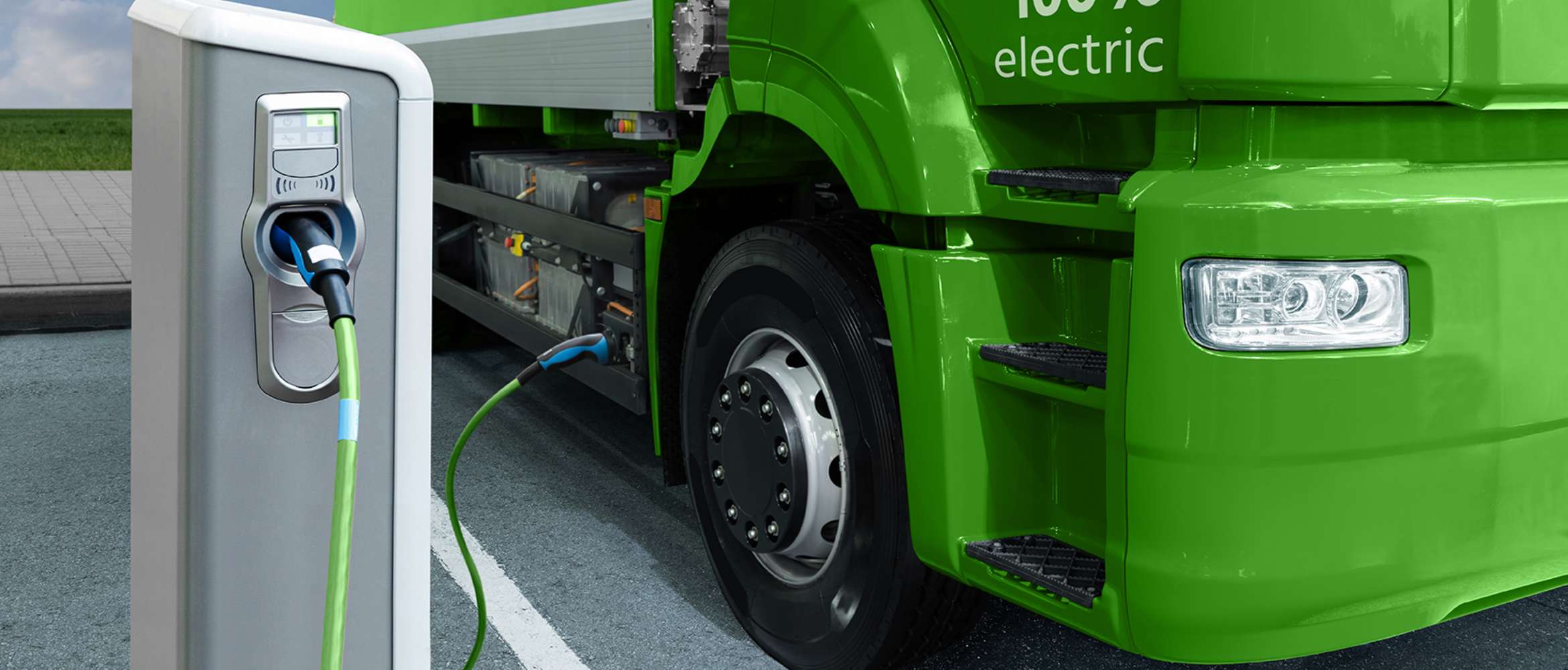 Un camion électrique se trouve à une station de ravitaillement ou de recharge et est branché dans cette scène de transport et de logistique