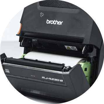 L'imprimante mobile Brother RJ ouverte montrant un rouleau d'étiquettes blanches