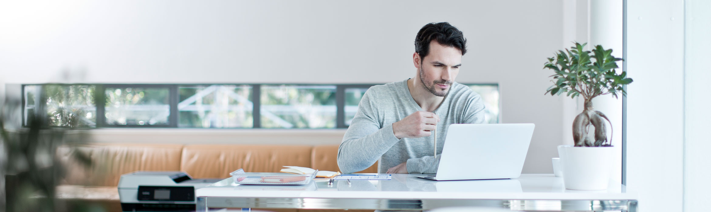 Man sat on laptop at desk