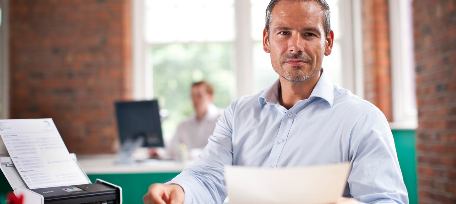 Man holding scanned document