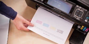 Closeup of a person collecting a printed document