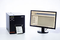 TJ industrial label printer next to computer screen