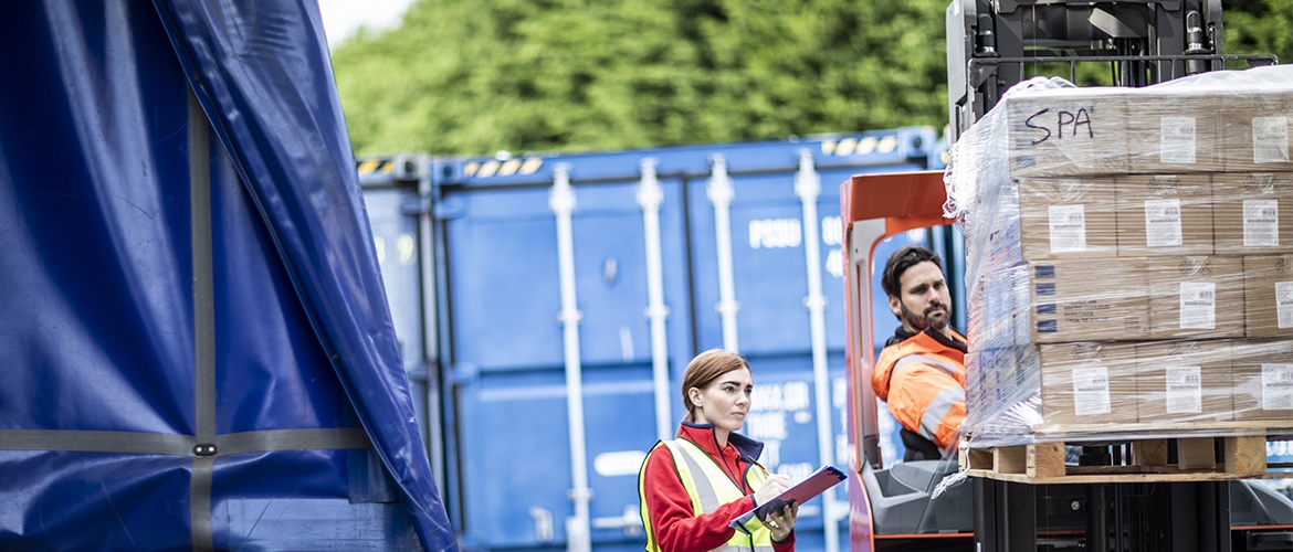 movimentazione merci: due addetti alla logistica preparano la spedizione