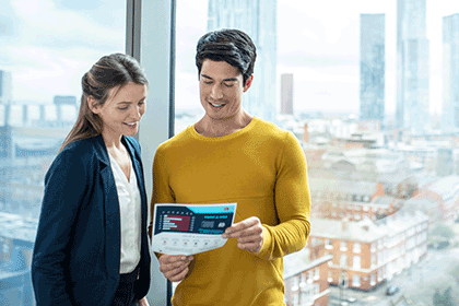 Uomo con documento A4 a colori in mano e donna in ufficio, edifici, finestra di vetro