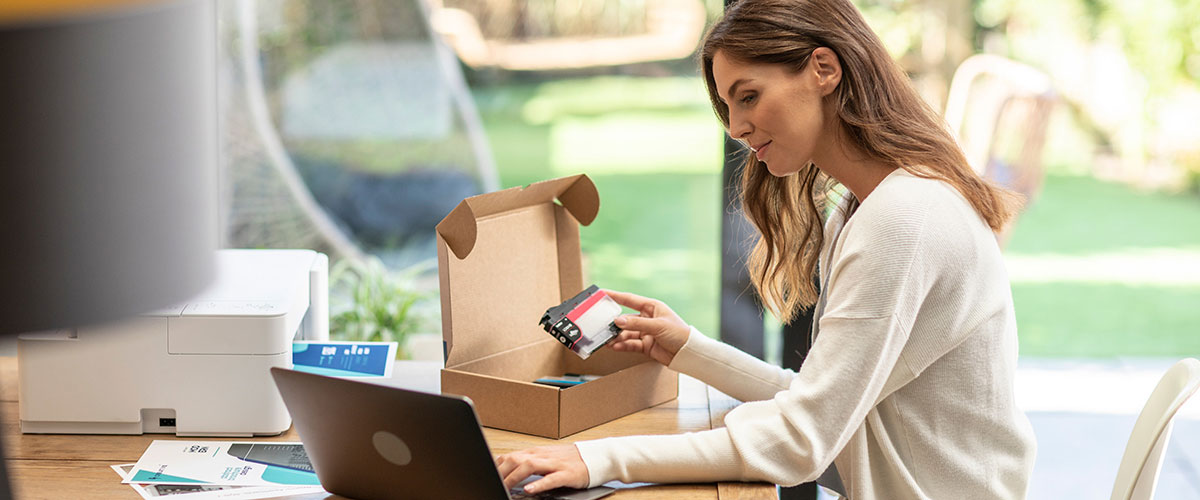 Small business owner changing ink using their print subscription service