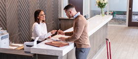 Woman and man signing in register