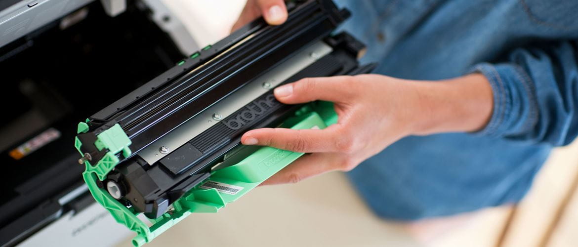 A man holding a Brother toner cartridge