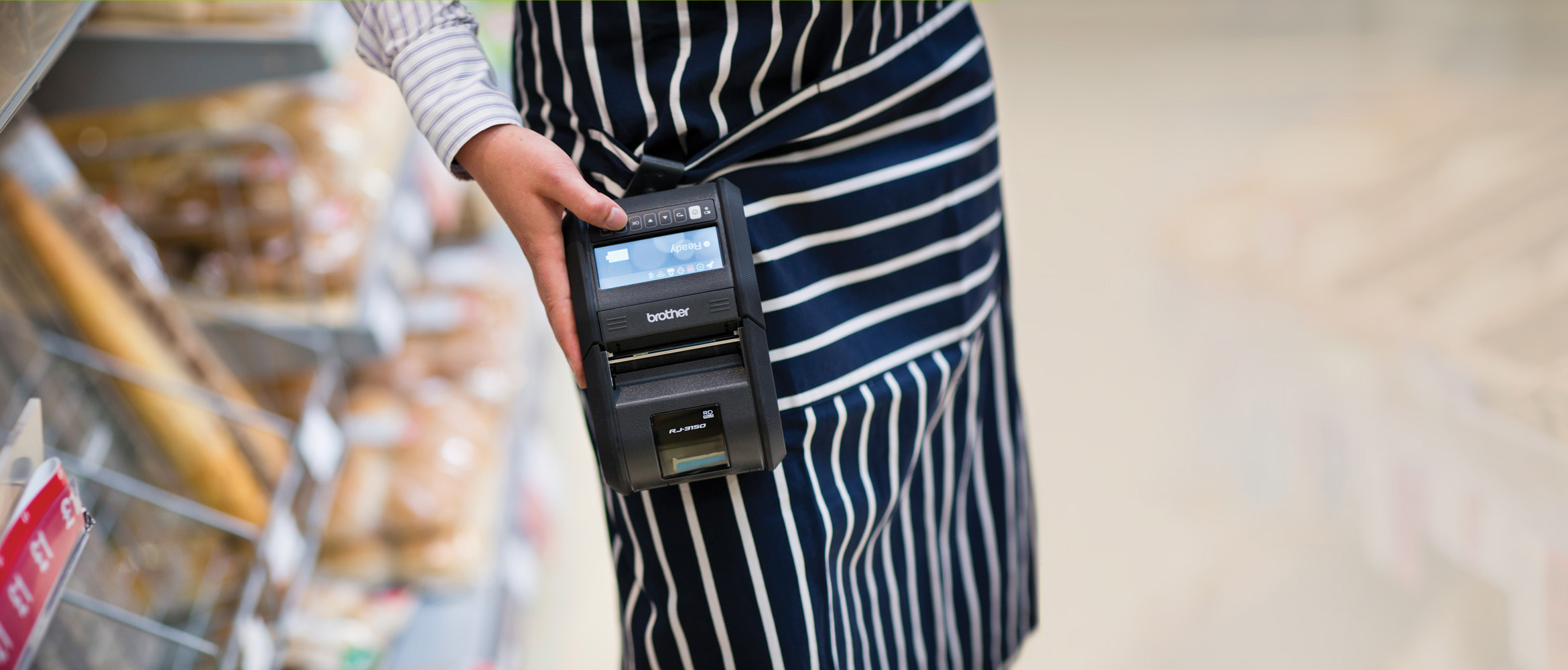 Retail staff wearing RJ-3150 Brother device in store environment