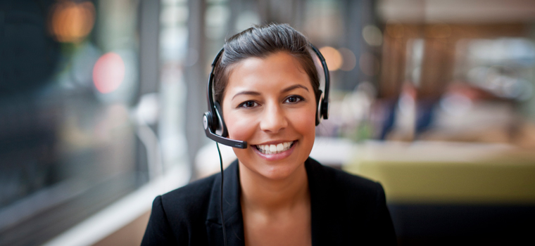 Woman with hair tied back sat with a headset on head