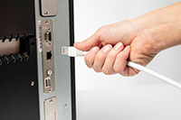 Ethernet cable being plugged into back of TJ industrial label printer