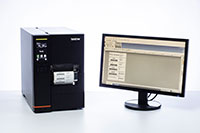 TJ industrial label printer next to computer screen