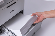 Brother MFC-L6710DW printer with paper tray open paper being inserted