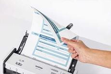 Person holding 2 sided A4 document in ADF of Brother ADS-1300 scanner