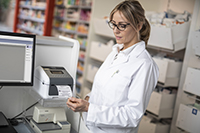 Lady doctor printing a label for medical files from a TD-4D series label printer