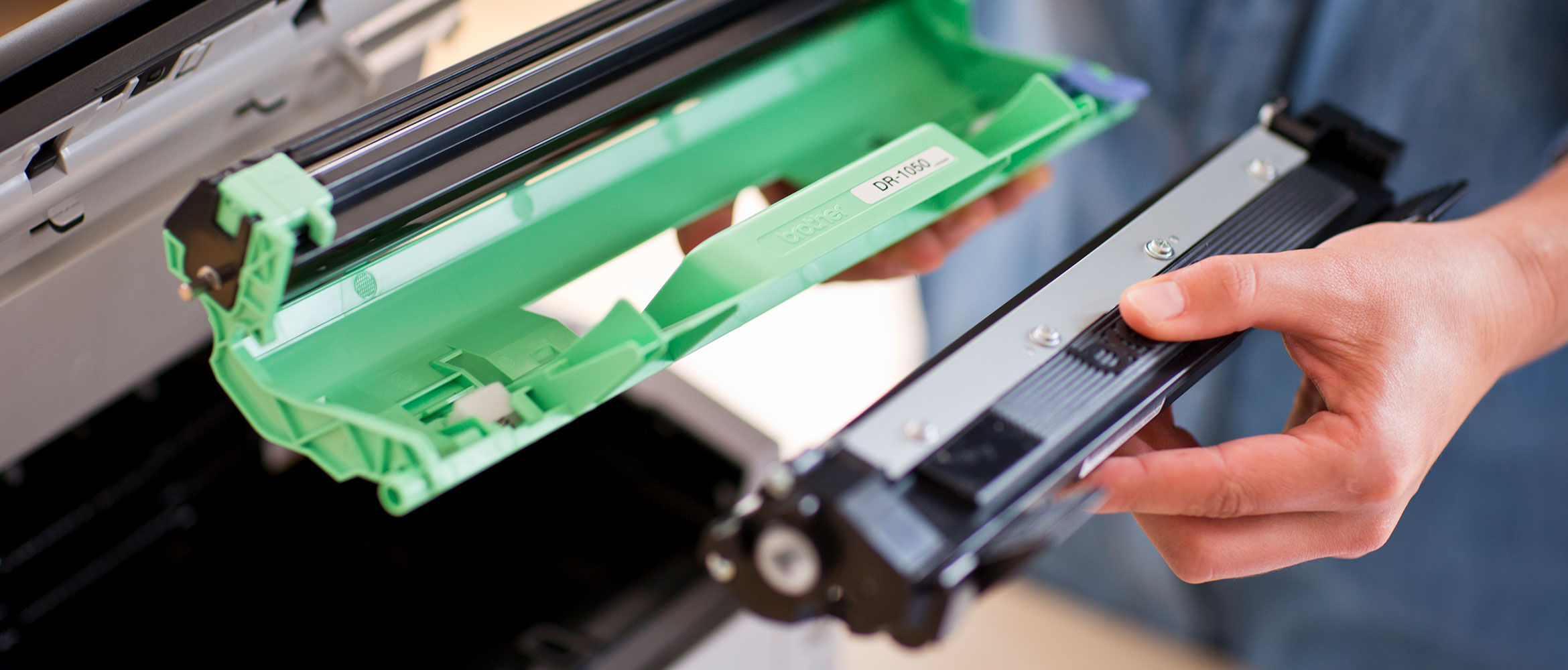 Man holding Brother cartridge and toner