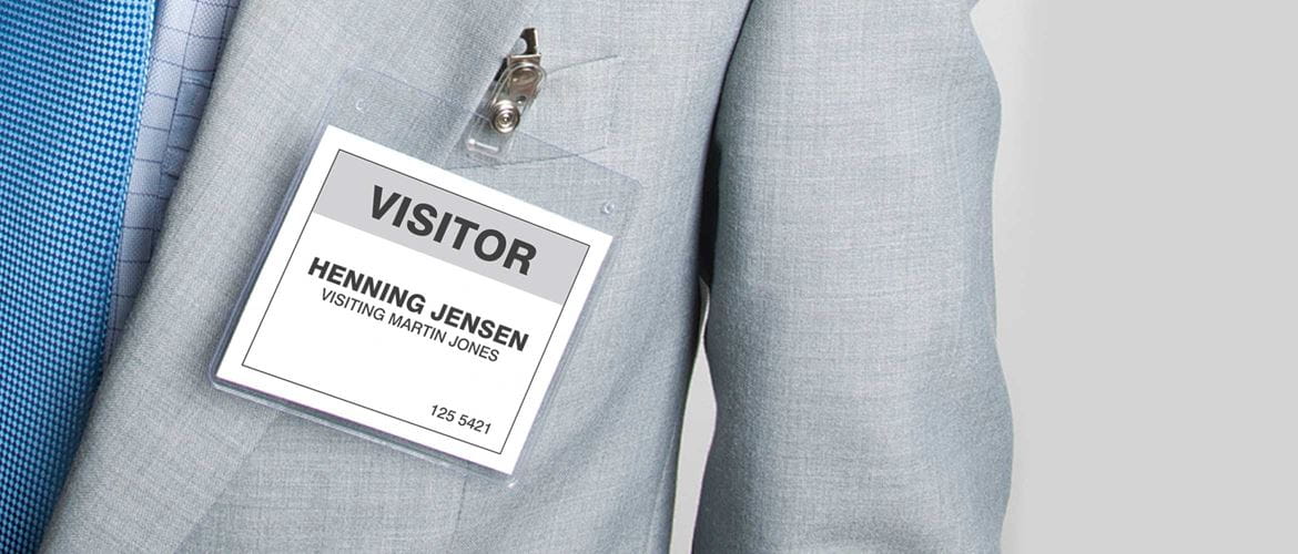 Visitor badge on man dressed in suit