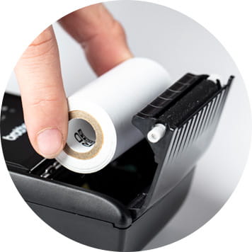 Hand placing receipt roll into Brother RJ printer
