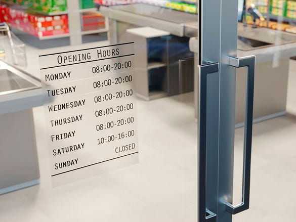 Shop opening hours sign made up of multiple Brother TZe durable black on transparent labels