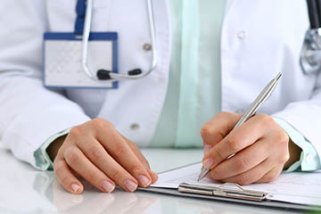 Doctor signing paper