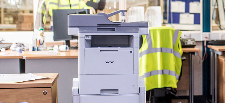 Brother floor standing printer in warehouse office, hi-vis, window, paperwork