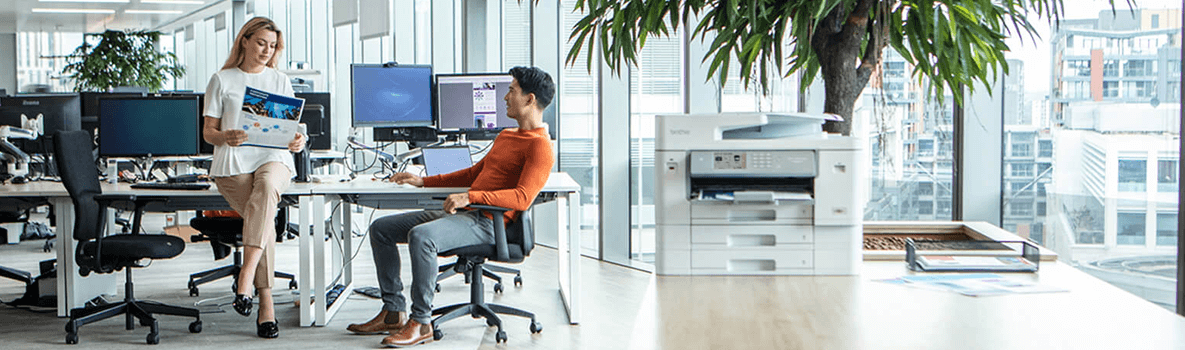 Woman at a desk with a computer and a headset on