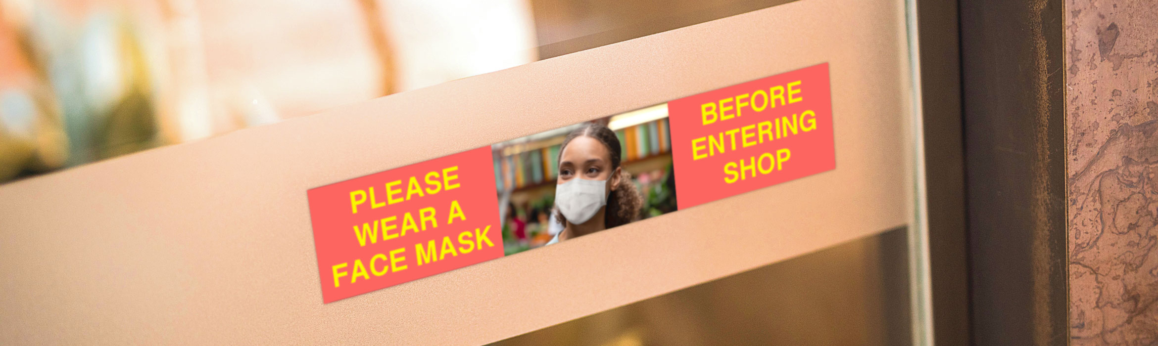 Full colour sign on shop door asking customers to wear a mask