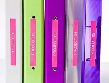 grey, green, purple, transparent grey, and transparent purple folders, on a shelf