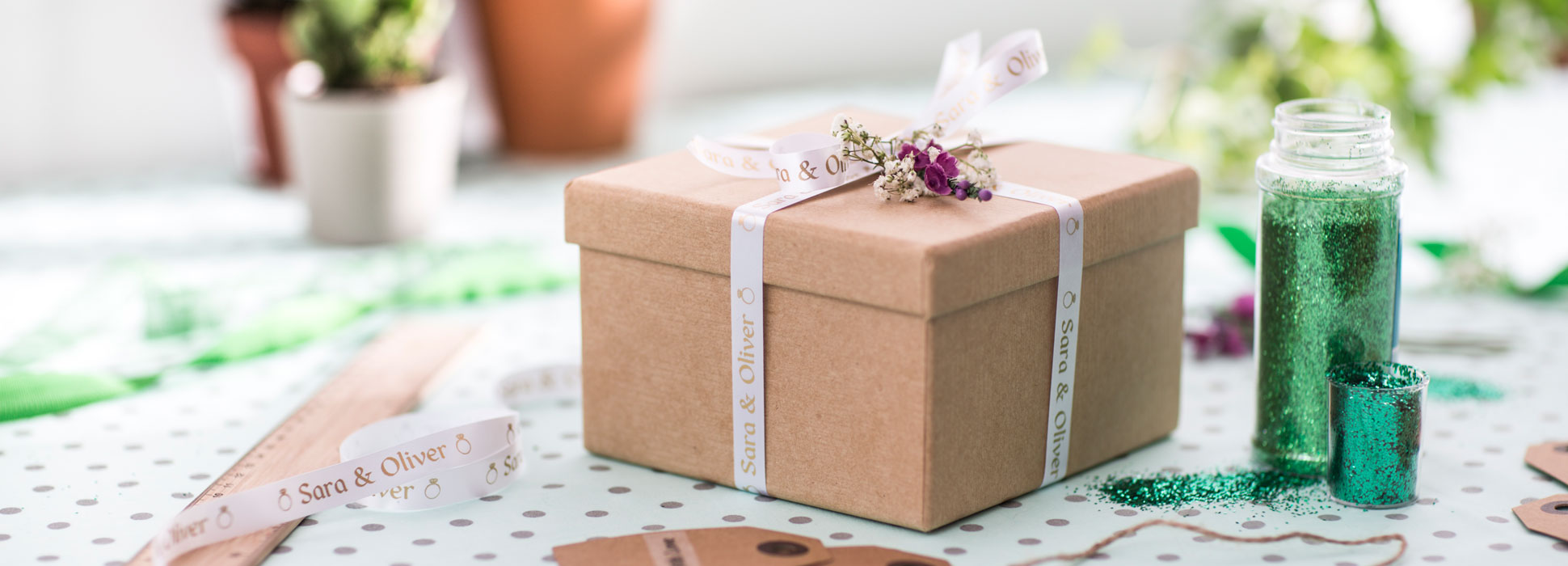 Wedding gift being wrapped with a personalised Brother gold on white ribbon