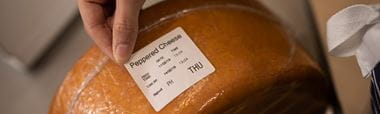 Suureen juustokiekkoon kiinnitetään tuotetietotarraa
