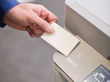 Person using an ID card to access a Brother printer