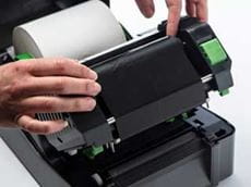 Thermal transfer ink ribbon being installed in a TD-4D label printer