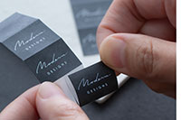 P-touch CUBE Pro PT-P910BT with labels half cut to make them easy to peel