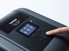 TD-4T desktop label printer screen close up with finger pressing button