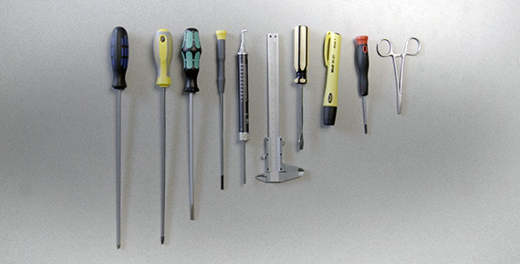 Screwdrivers calipers scissors on a table