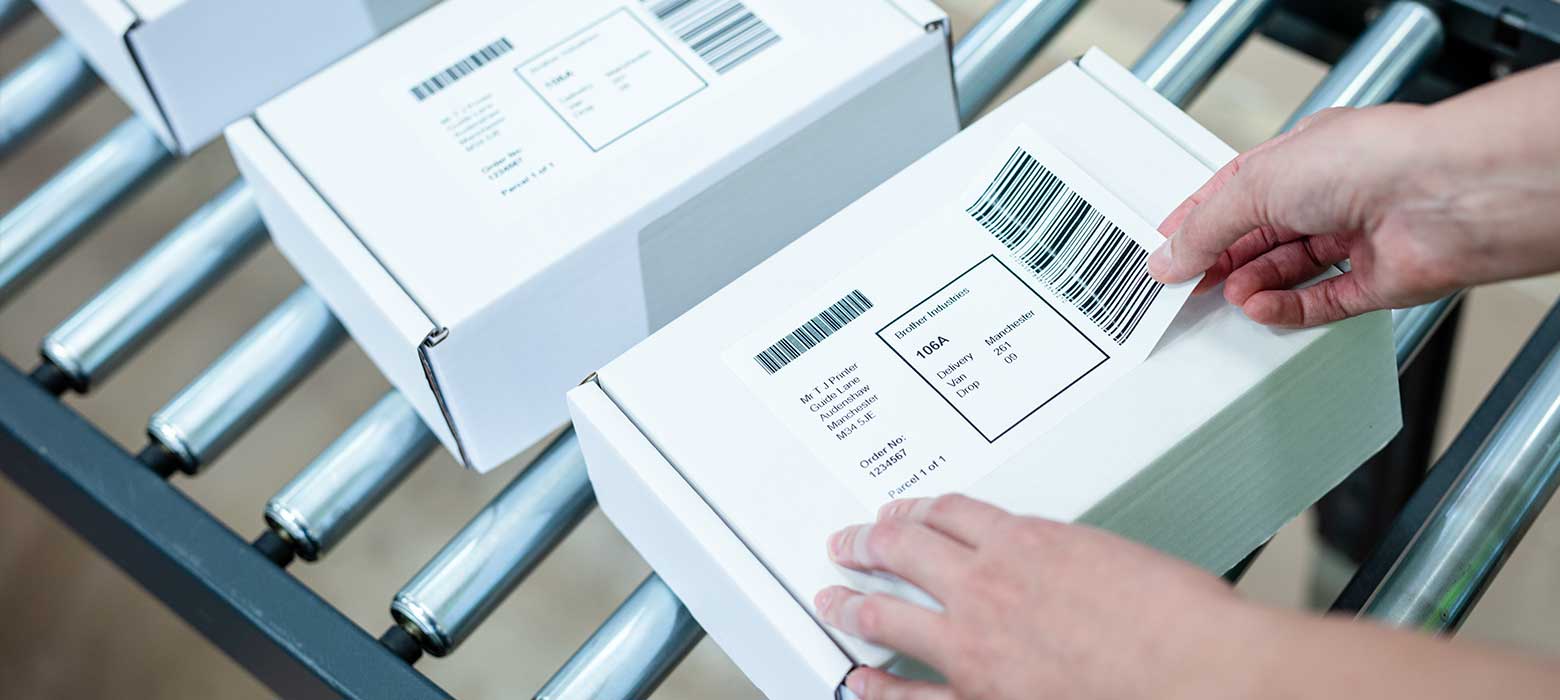 White box with delivery label being attached in fulfilment centre