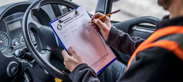 In vehicle printing, drivers daily log on clipboard being filled in by driver