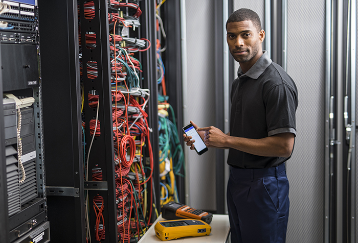 Man using Brother Fluke Networks app with Labelling machine