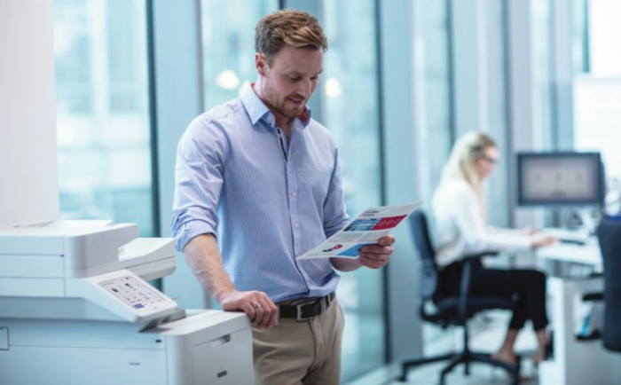 men standing next to Brother EC laserprinter