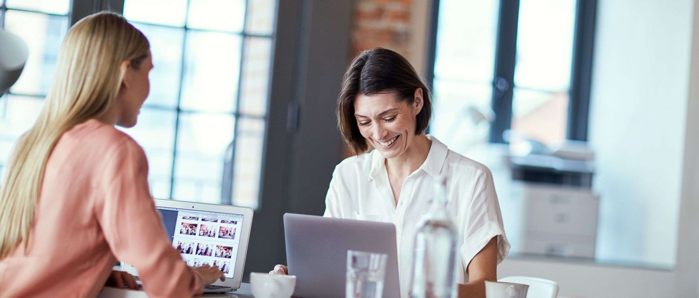 A woman sitting at her desk using her laptop