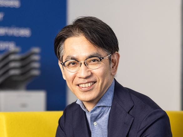 Isao Noji Managing Director of Brother International Europe sat on a chair smiling