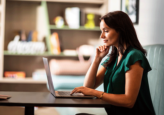 Woman working on laptop in home envrionment