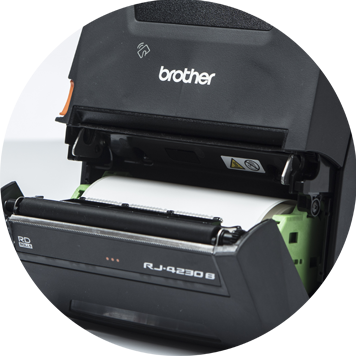 Brother RJ mobile printer open showing roll of white labels
