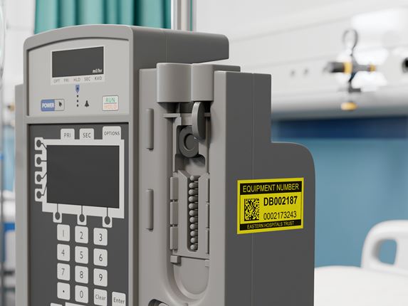 Brother P-touch black on yellow asset label on hospital medical equipment 