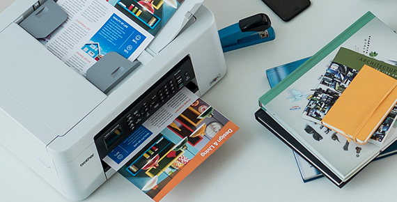 Printer on table printing colour document
