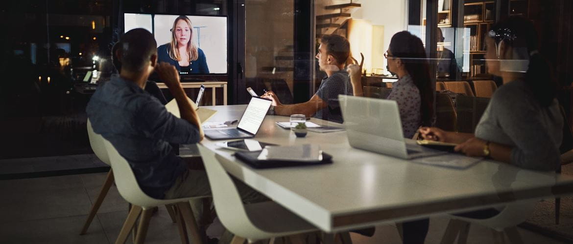 Small medium business employees improve collaboration by using web conferencing to speak to a colleague on a screen