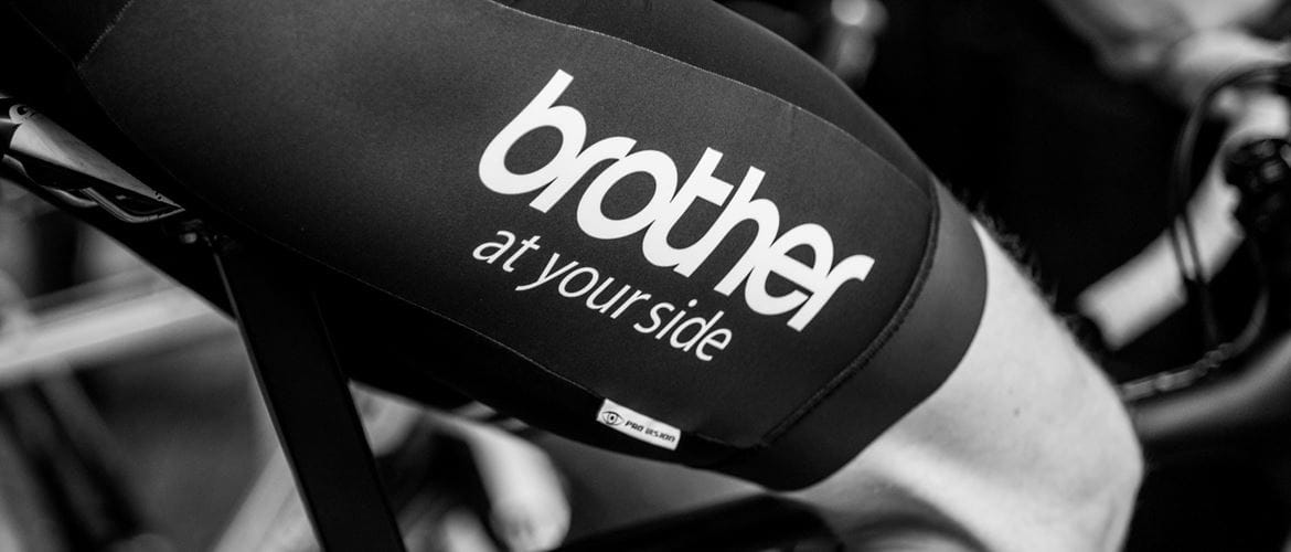 cyclist peddles in Brother branded kit
