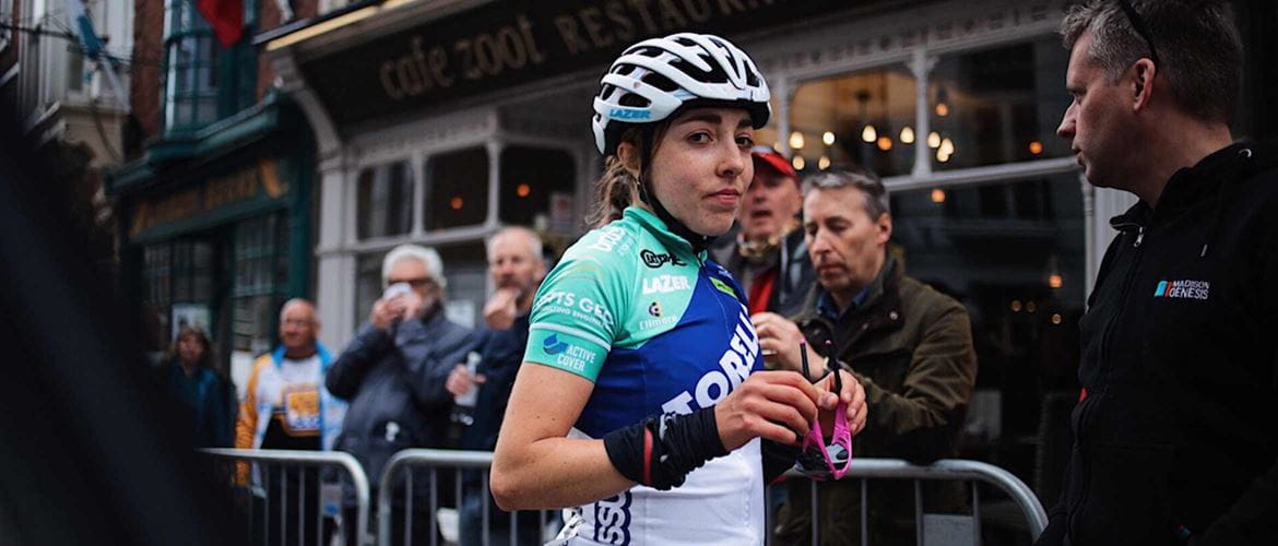 Cyclist Sophie Wright looking at the camera and holding her sunglasses in her hand