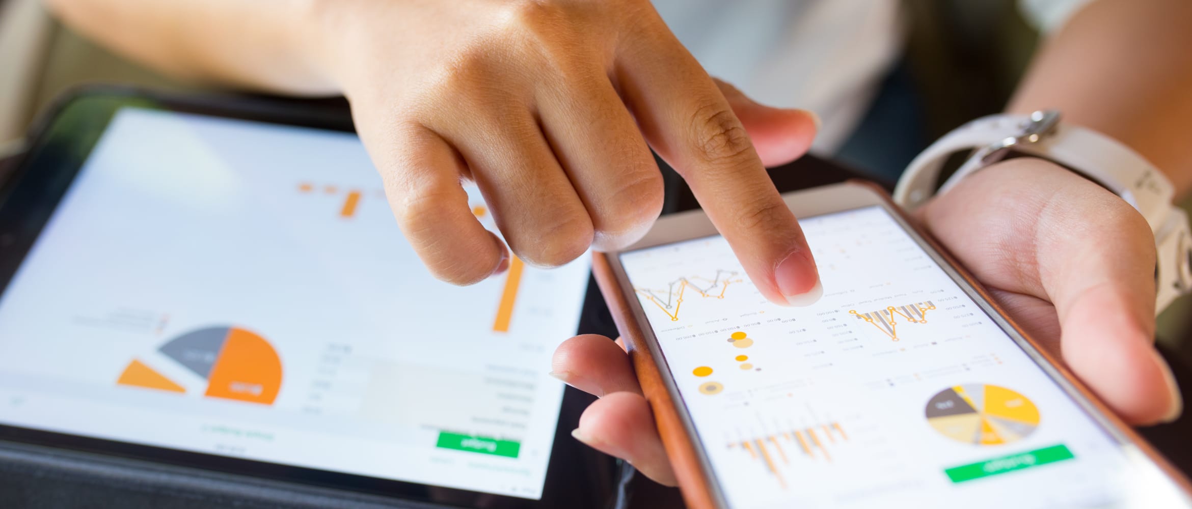 Businesswoman checking data on smartphone and tablet device